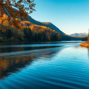 Anglers fishing in a scenic lake during autumn.