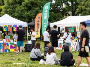 Community members enjoying the Chapin Fall Art Festival with art displays in a park